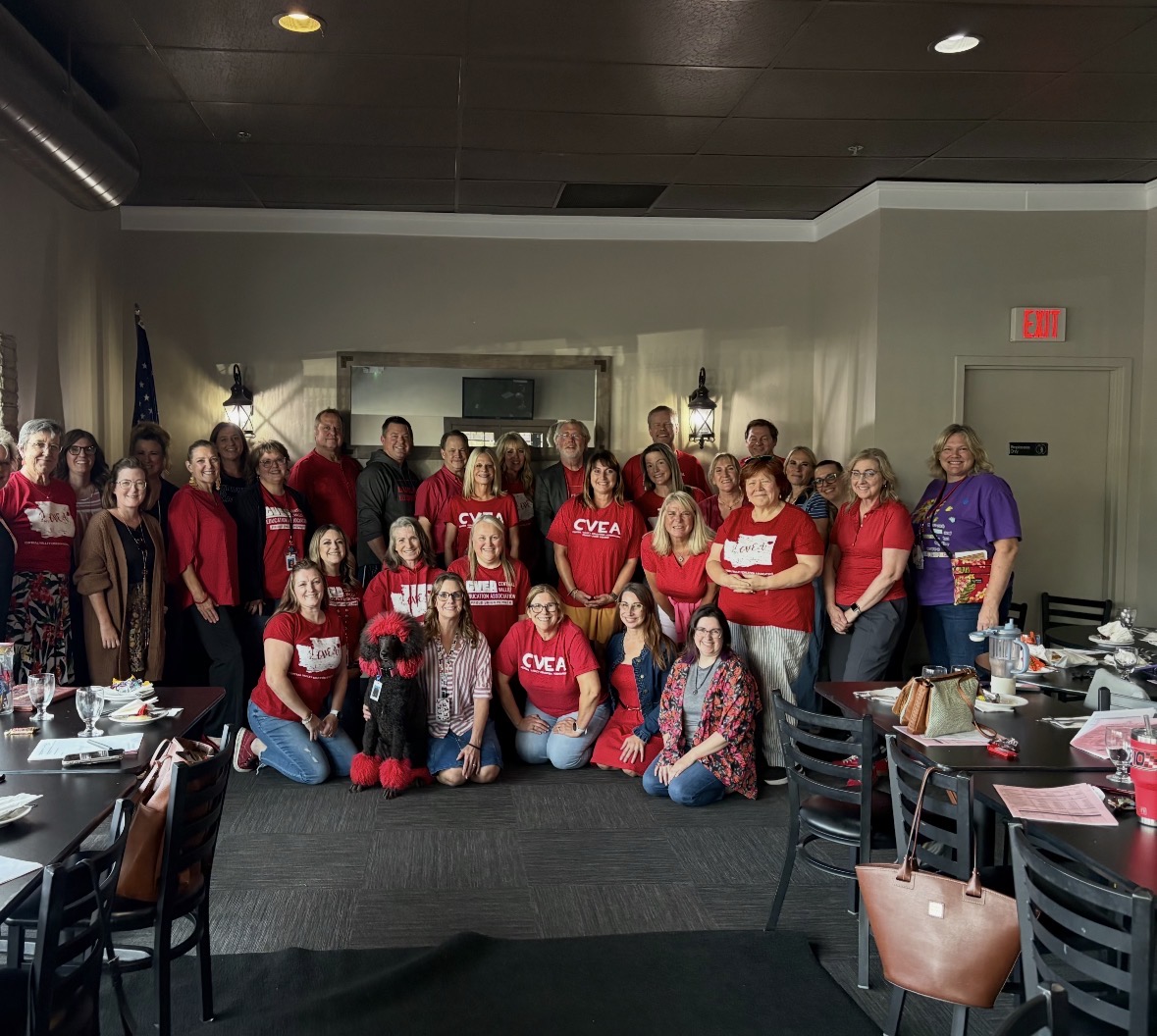 CVEA Rep Council members wearing red for Wear Red for Ed, with the group's dog Rebel in the front row